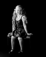 Little girl on a black background