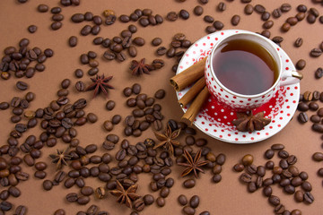 spicy black coffee polka dot mug and coffee beans mess on brown  background