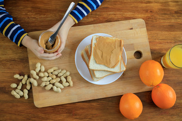 Boy is holding peanut butter jar