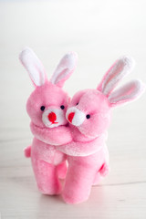 Pink toy bunnies hugging in valentines day