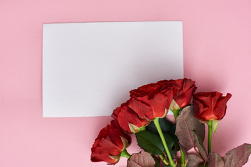 The wish of love. Note paper for your love letter and bouquet of fresh roses.