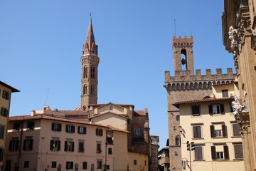 Fototapeta na wymiar Bell tower of the Badia Fiorentina church view from the Piazza San Firenze at historic center of Florence, Tuscany, Italy