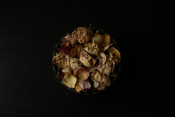 Photo of dried rose petals on a black background
