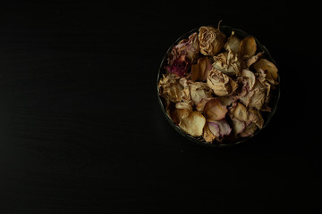 Photo of dried rose petals on a black background