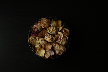 Photo of dried rose petals on a black background