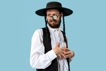 Portrait of a young orthodox Hasdim Jewish man at Jewish festival of Purim at studio. The purim, jewish, festival, holiday, celebration, judaism, tradition, religion concept.