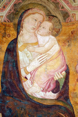 Virgin Mary with baby Jesus, fresco on the house facade in Florence, Italy