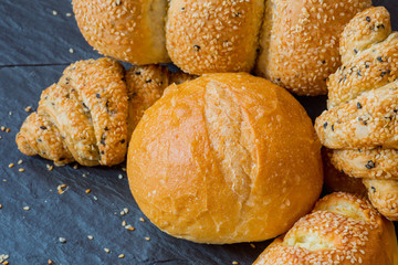 Traditional homemade bakery bread with sesame, Stack of fresh bread on stone table.Closeup traditional homemade bakery bread with sesame.