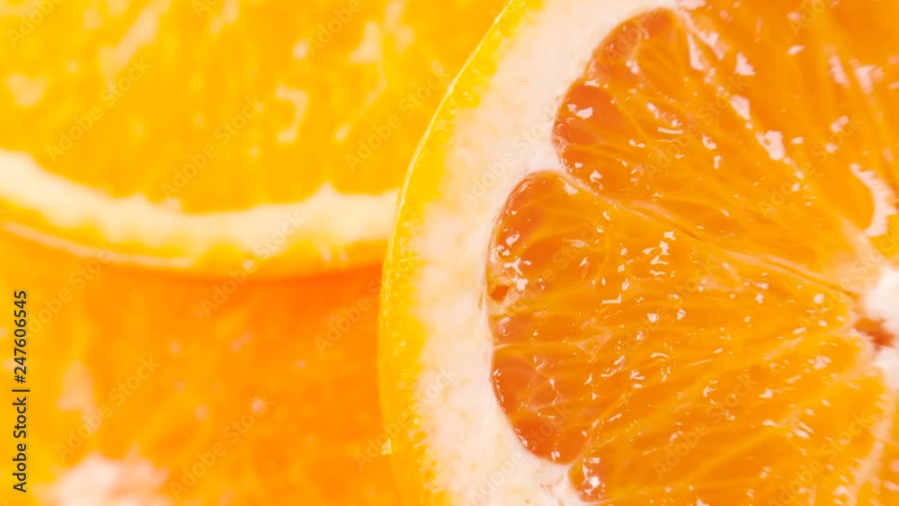 Wall mural sliced ripe orange with drops of juice. Closeup macro shot. Fresh berry series. 4k