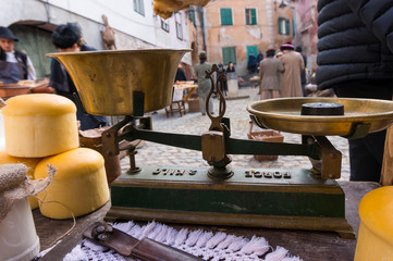 Antique vintage balance in medieval marketplace