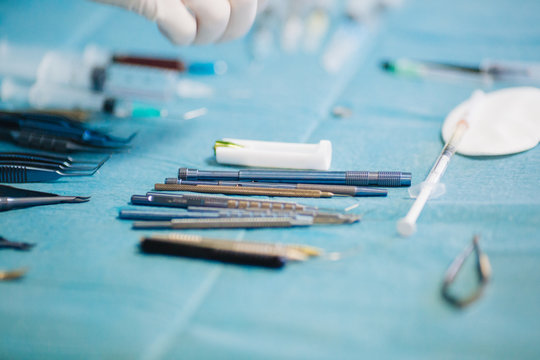 Surgical instruments lie on a sterile table in the operating room.