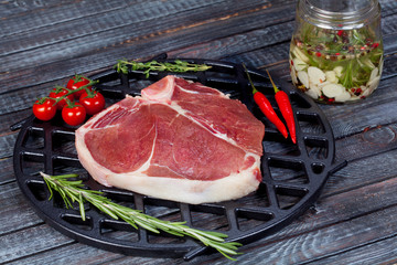  beautiful and juicy raw steak on the table with ingredients ready to roast