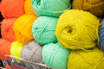 Coloured wool yarn into skeins and tangles. Bright yarn for knitting.