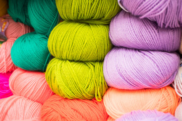 Coloured wool yarn into skeins and tangles. Bright yarn for knitting.