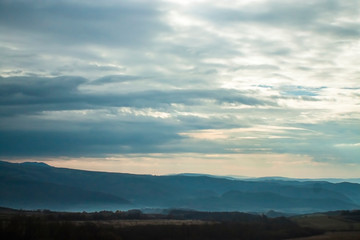Fototapeta premium Clouds over misty mountains