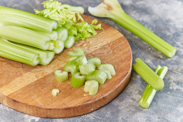 Macro sliced Celery on wooden chopping board. 