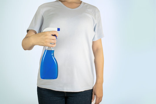 Image view above, flat lay detergent. The concept of Service for cleaning apartments and premises, cleanliness. Woman in a t-shirt holding a detergent. Housewife, maid cleans the house