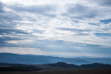Clouds over misty mountains