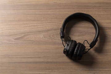 Headphones on dark wooden background