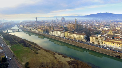 AERIAL. Panorama of the city of FLORENCE in Italy with the dome and Palazzo della Signoria and arno river