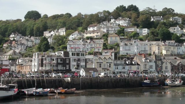 Harbour and quay wall with houses on the hillside, Looe, Cornwall