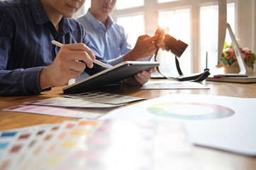 Photographer Colleagues discussing photographs at creative office, Photo editor job.