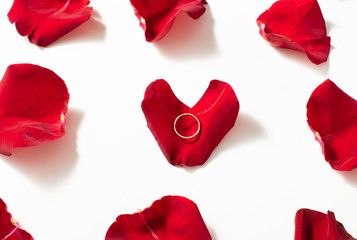 Wedding ring red box surrounded by rose petals. An offer of marriage
