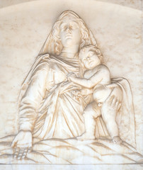 Fototapeta na wymiar Madonna with the Child, by Andrea Gurdi lunette over the portal of Cathedral in Pisa, Italy. Unesco World Heritage Site