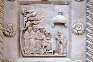 Washing of the Feet on the San Ranieri gate of the Cathedral St. Mary of the Assumption in Pisa, Italy 