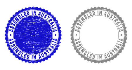 Grunge ASSEMBLED IN AUSTRALIA stamp seals isolated on a white background. Rosette seals with grunge texture in blue and grey colors.
