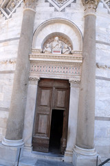 Obraz premium Entrance door of the Leaning Tower of Cathedral in Pisa, Italy. Unesco World Heritage Site