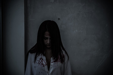 Close up woman wear white shirt in the dark room,Scary movie concept,Horror background,Thailand people