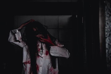 Portrait of asian woman make up ghost face with blood,Horror scene,Scary background,Halloween...