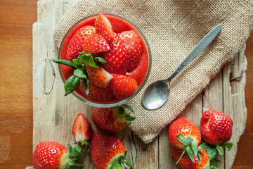 Low Carb Strawberry and chia puddings in a glass, wood background