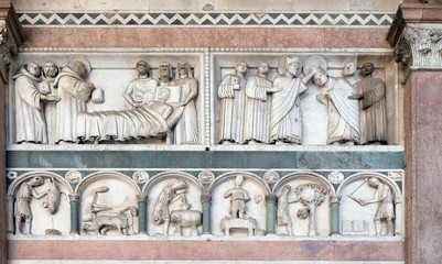 Detail of the bas-relief representing the Stories of St. Martin and the Labor of the months of the year; preserved in the Portico of the Cathedral of St. Martin in Lucca, Italy