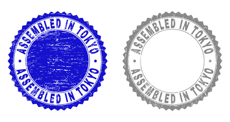 Grunge ASSEMBLED IN TOKYO stamp seals isolated on a white background. Rosette seals with grunge texture in blue and gray colors.