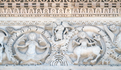 Bass relief on the Portal of San Michele in Foro Church in Lucca, Italy
