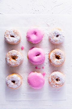 Fresh donuts with powdered sugar and icing