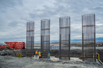 Armature round columns for the construction of bridges in the background of mountains