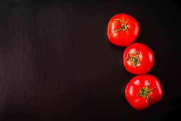 Tomatoes on a black background