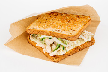 Tasty sandwich with slices of chiken, cheese and fresh organic vegetables