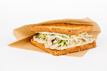 Tasty sandwich with slices of chiken, cheese and fresh organic vegetables
