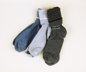 three pairs of socks arranged on the white cloth