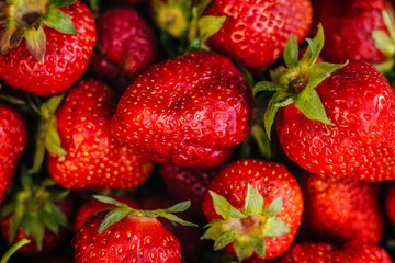 Red strawberries on a white plate. A lot of berries. Summer fruits