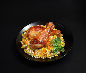 grilled chicken legs with sesame and rice on a black background.