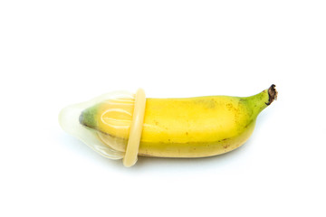 Fototapeta na wymiar A picture of a baby banana with a normal regular condom. Showing the problem of small or micro penises