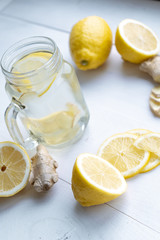 Vertical. Vitamin tea made of sliced lemons and ginger root