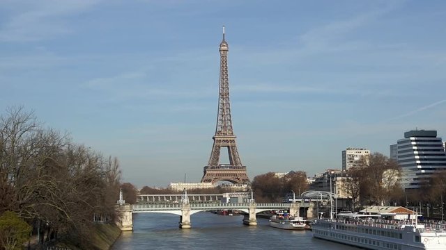 Train traffic (RER) on Railway bridge (Pont Rouelle) with Eiffel tower in background - Paris, France
