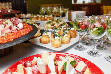 dishes on the table, salads in glasses, snacks, reception