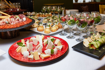 dishes on the table, salads in glasses, snacks, reception